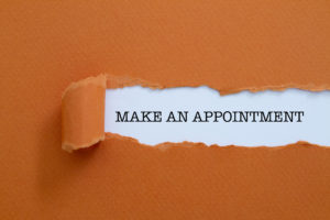 Make an appointment written under torn paper.