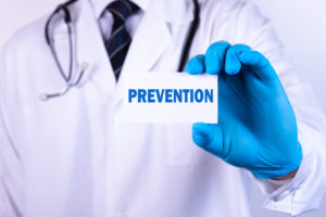 man in medical coat holding paper that says prevention